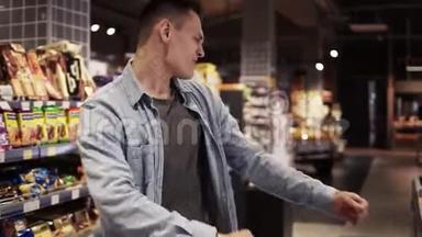 超市里的男人用购物车跳舞。 在空<strong>食品店</strong>积极跳舞