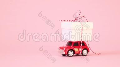 红色复古玩具车送礼盒，带丝带蝴蝶结在粉红色背景上。 生日、情人节`妇女节视频