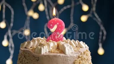 生日蛋糕，蓝色背景上有2个数字粉红色燃烧蜡烛。 蜡烛吹灭了。 慢<strong>速运</strong>动和特写镜头