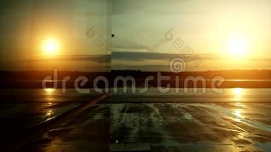 日落时起飞飞机在机场窗口的反射。
