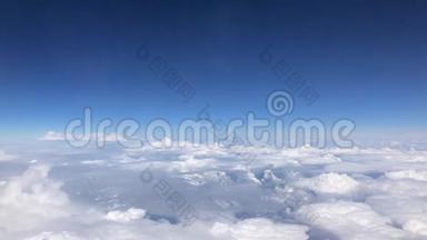 令人惊叹的画面从蓝天的飞机窗口上方的云层。 从飞机窗口到
