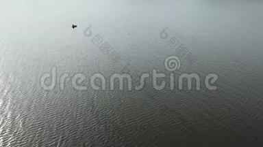 空中无人机在湖上的一艘小<strong>渔船</strong>上向<strong>渔民</strong>射击。 美丽的夏日风景湖.. 鸟瞰图