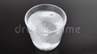 一个泡腾的药片溶解在一个发出大量<strong>气泡</strong>的玻璃中。 宏观视频的<strong>气泡</strong>和药丸溶解。