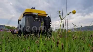 关闭燃气柴油移动式便携式发电机工作在草地上。 汽油燃料动力便携式发电机