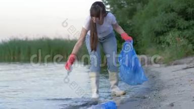 环境问题，年轻的活动家女孩穿着橡胶靴清理海滨的塑料垃圾和收集
