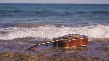 波浪把吉他扔在空岸或石滩上。 潮把吉他带上岸.. 吉他游泳，游泳，漂流，漂浮