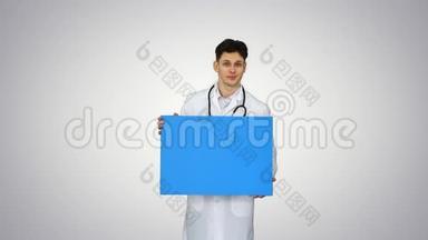 微笑男<strong>医生</strong>穿着听诊器，在梯度背景上拿着空白<strong>海报</strong>。