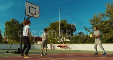 一家人在运动场上打篮球。