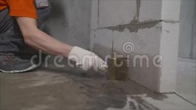 工人用刷子把混凝土地板弄湿。 防水用底漆混凝土地板