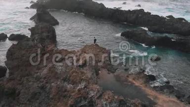 空中观景。 一个三角形的美丽海湾-那家伙站在<strong>悬崖</strong>上，旁边是<strong>天然</strong>的游泳池。 特内利夫