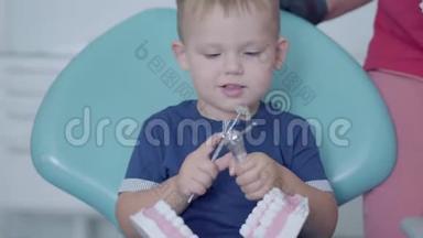 牙医办公室里可爱的小男孩在女医生和护士的帮助下玩下巴模拟。 <strong>免费儿童</strong>