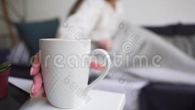 拉格姆概念-女孩喝一杯白咖啡，站在桌子上，喝一杯热饮料，享受简单和简单