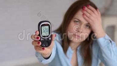 患有糖尿病的妇女持有血糖仪，血液中的葡萄糖率很高。