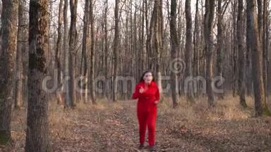 <strong>绿油油</strong>的胖姑娘穿着红色的衣服穿过秋天的森林。 停下来放松