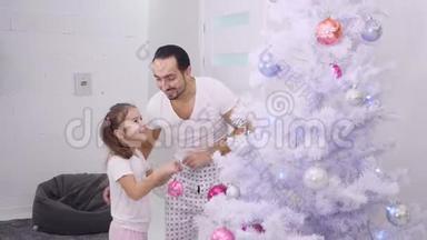 小女儿想把粉红色的宝布尔挂在树的顶枝上，<strong>所以</strong>爸爸挑选她，然后他们拥抱着她