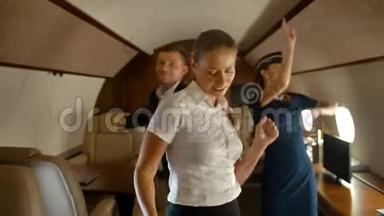 富有的商务同事和空中小姐在飞机头等舱内跳舞