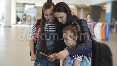 母亲和女儿<strong>在机场</strong>检查机票，然后才报名。
