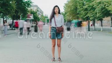 站在城市步行街看镜头的亚洲女士的时间流逝