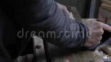 男木匠用千斤顶刨木木板做松木架子，并<strong>加以</strong>检查
