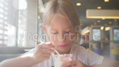 漂亮女孩在咖啡馆里吃<strong>冰淇淋</strong>。 孩子吃<strong>冰淇淋</strong>的生活方式理念..