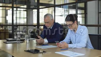 两位办公室经理在等待业务客户的智能<strong>手机</strong>上<strong>输入</strong>电子邮件