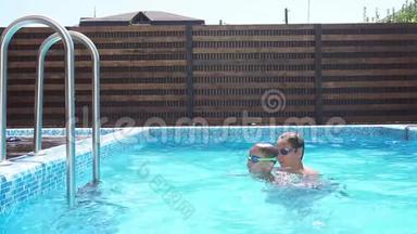 孩子和他的小男孩弟弟在游泳池里玩得很开心，慢动作。 一家人夏天在游泳池里玩。