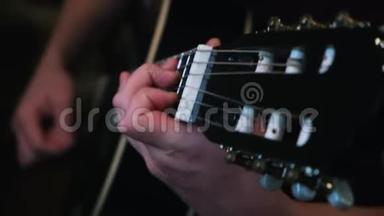 音乐和艺术的概念.. 概念。 用黑色吉他演奏人的双手特写