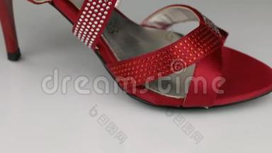 宏观，特写.. 缓慢旋<strong>转</strong>的红色妇女`<strong>凉</strong>鞋的白色背景。