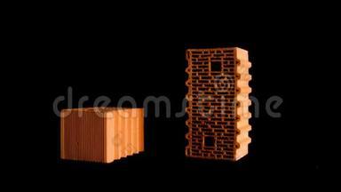 关闭两个橙色砖块隔离在黑色背景上。 库存录像。 建筑和建筑材料概念，