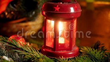 为庆祝圣诞或圣诞而装饰的木桌上的红色装饰灯笼内点燃蜡烛的特写4k视频