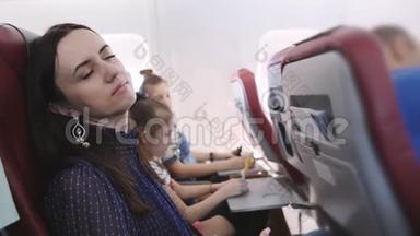 乘坐飞行飞机的旅行者会感到恶心。 飞机上的女人吐在纸袋里。 在飞行中的恶心乘客