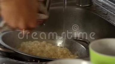 女人在家做饭-在煮的面食上浇冷水