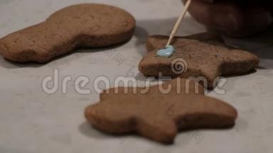 圣诞饼干躺在桌子上。 孩子们`用一种蓝色的奶油，用一种<strong>星号</strong>形状的姜饼饼干