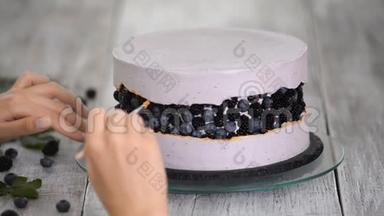 一步一步地准备浆果<strong>蛋糕</strong>。 糖果师用金色的食物颜料装饰一个<strong>紫色</strong>的<strong>蛋糕</strong>。