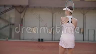 漂亮的女网球运动员在网球场上打球。 职业网球运动员慢动作
