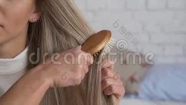 头发有问题的女人。 那个女孩坐在家里，注意<strong>到头</strong>发状况不好。