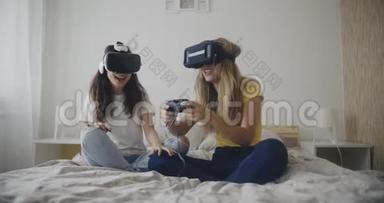 两个年轻的女人在卧室里玩虚拟现实游戏。 虚拟现实，米勒，娱乐，爱好概念。 拍摄于红色。 12比特色