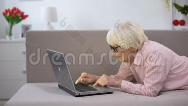 快乐的<strong>老太太</strong>在家里打手提电脑，为老年人工作，自由职业
