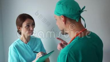一名男医生和一名女实习生讨论工作问题。 工作的医务人员