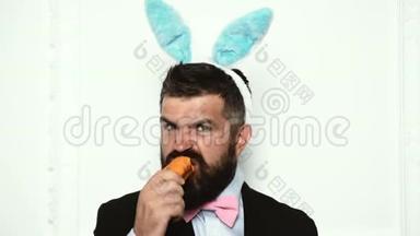 复活节快乐，复活节有趣。 兔兔人吃白色背景上孤立的胡萝卜。 可爱的小兔子。 庆祝活动