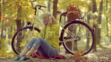 秋天和树叶飘落的梦想。 耳机概念。 无忧无虑的女人。 户外<strong>大气时尚</strong>照片年轻美丽