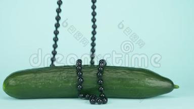潮流艺术美食设计.. 黄瓜有一串黑色的珠子。 蓝色背景