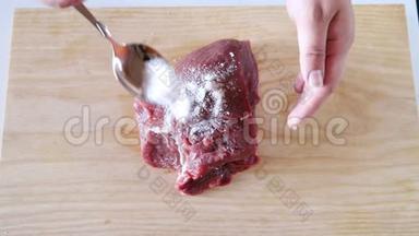 女人盐牛肉。 人把肉腌好，用盐擦它