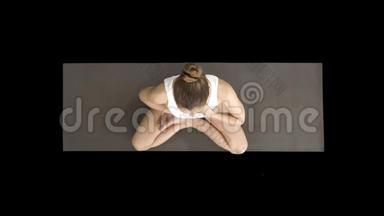 瑜伽女孩以莲花姿势呼吸，双手放在腹部和胸部，阿尔法通道