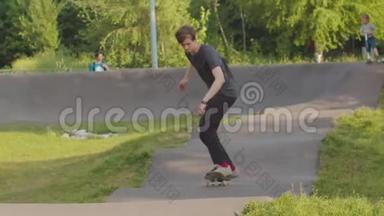 年轻人训练他的滑板技能。 在波浪形的马路上溜冰
