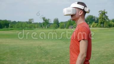 一个男人在公园里用VR耳机把头转向照相机