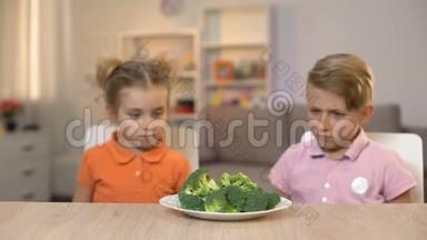 两个孩子嗅着新鲜的西兰花，美味的<strong>饭菜</strong>，无味的健康食品
