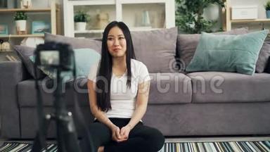 可爱的亚洲女孩女博客正在为她的网络博客录制视频，看着相机，微笑着交谈