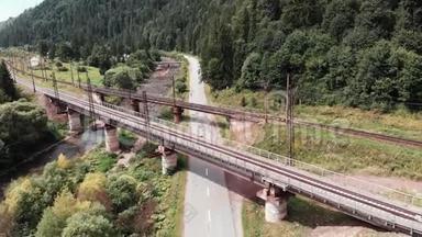 鸟瞰老混凝土铁路桥.. 无人机在两座铁路老桥附近飞行。 骑自行车女孩在铁路附近骑自行车训练