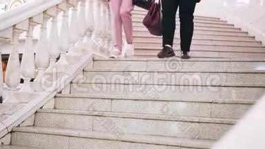 两个女<strong>人下</strong>了商场的<strong>楼梯</strong>。 腿的特写。